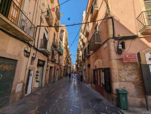 an empty street in an alley between buildings at La Paloma in Tarragona