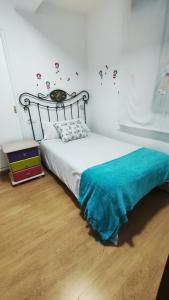 サンティアゴ・デ・コンポステーラにあるApartamento Rio Sar garaje incluidoのベッドルーム1室(青い毛布付きのベッド1台付)