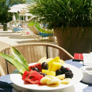 a plate of fruit on a table at a resort at Laguna Park Hotel 4Superior in Bibione