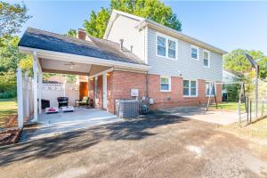 a house with a large patio in front of it at Centrally Located Spacious Abode in Charlotte