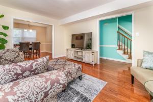 a living room with two couches and a table at Centrally Located Spacious Abode in Charlotte