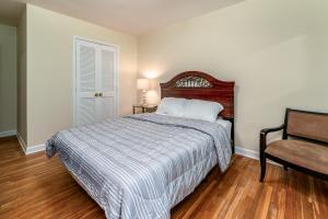 a bedroom with a bed and a chair at Centrally Located Spacious Abode in Charlotte