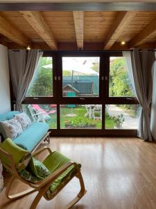 a room with a rocking chair and a large window at Il Nido della Buonanotte 2 KIDS friendly in Verona