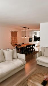 a living room with a white couch and a table at Dune Du Clémot in Blankenberge