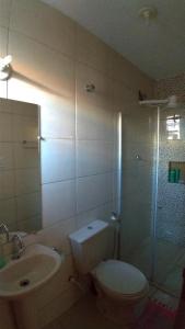 a bathroom with a toilet and a sink and a shower at Hostel Miscelânea in Sete Lagoas