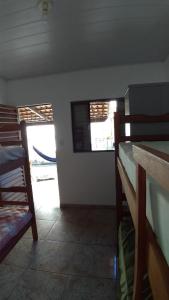 a room with two bunk beds and a window at Hostel Miscelânea in Sete Lagoas