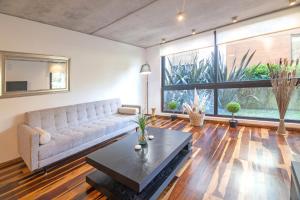 a living room with a couch and a table at Be House & Spa by Oceana Suites in Punta del Este