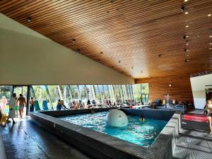 a swimming pool with people in the water at JUFA Hotel Seckau - Self Check-in in Seckau