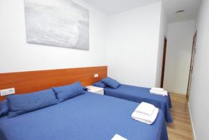 Postel nebo postele na pokoji v ubytování Hotel Tres Leones