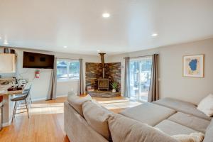 a living room with a large couch and a kitchen at Cozy Lake Tahoe Home with Yard, Near Ski Resorts! in South Lake Tahoe