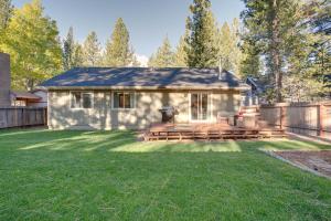 a small house with a deck in a yard at Cozy Lake Tahoe Home with Yard, Near Ski Resorts! in South Lake Tahoe