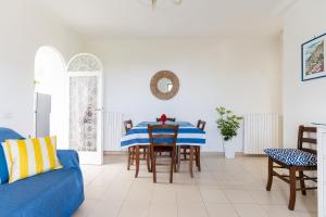 a living room with a blue couch and a table at Villa Fanella, between Sorrento & Amalfi in Piano di Sorrento