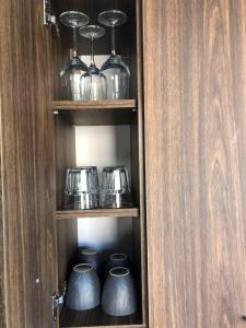 a cupboard with some pots and pans in it at Studio Flat in London