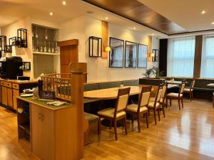 a restaurant with a long table and chairs at Hotel Restaurant Kreuz Spaichingen in Spaichingen