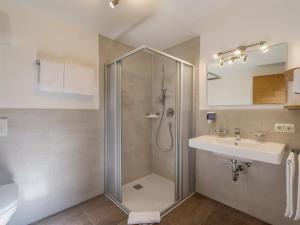 a bathroom with a shower and a sink at Gasthaus Steinberg in Westendorf