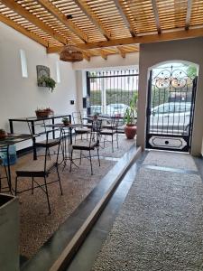 a dining room with tables and chairs and a glass door at Posada del Cerro in Salta