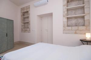 Posteľ alebo postele v izbe v ubytovaní Palazzo Degli Olivi