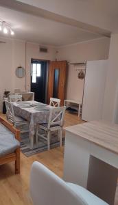 a dining room with a table and chairs in a room at Chic Apartment Subotica in Subotica