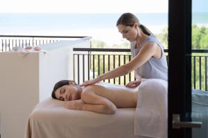a woman giving a woman a massage on a bed at Savoy Beach Hotel & Thermal Spa in Bibione