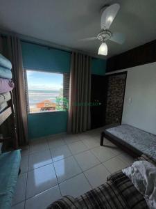 sypialnia z łóżkiem i dużym oknem w obiekcie apartamento na praia , pé na areia vista para o mar w mieście Mongaguá