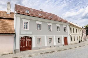 a white building with a red roof on a street at Just Jimramov in Jimramov