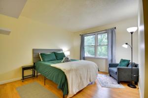 a bedroom with a bed and a chair and a window at Pet Friendly Charming Cozy Greensboro Gem! in Greensboro