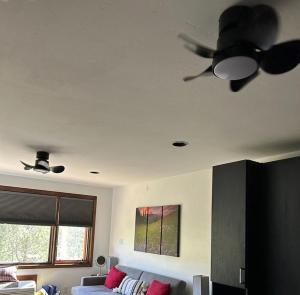 a living room with a ceiling fan and a couch at Tamarron Lodge Studio - 103 in Durango +51 photos