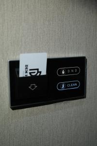 a black object with a card on a wall at Dem Premium Hotel - Round Trip Airport Service - Istanbul International Airport in Arnavutköy