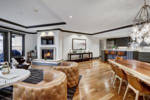 a living room with a table and chairs and a fireplace at Luxury 3 Bedroom Condo at The Arrabelle condo in Vail