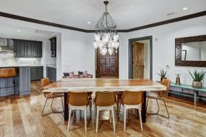a kitchen and dining room with a wooden table and chairs at Luxury 3 Bedroom Condo at The Arrabelle condo in Vail