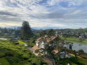 a view of a town with a river and houses at JL Grand Hotel in Nuwara Eliya
