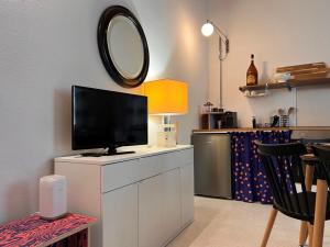 a living room with a television on a white cabinet at Garibaldina75 in Cesena