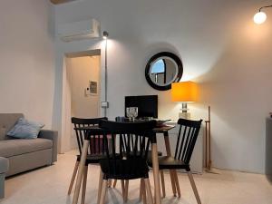 a living room with a table with chairs and a mirror at Garibaldina75 in Cesena