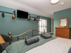 a bedroom with a bed with two pillows on it at Stillwater Cottage in Beverley