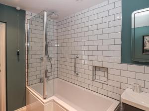 a white bathroom with a tub and a shower at Stillwater Cottage in Beverley +22 photos