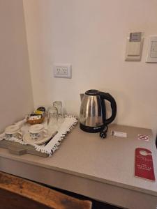 a kitchen counter with a tea kettle on a counter top at Posada del Cerro in Salta