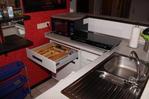 a kitchen with a sink and a microwave at Wohnen in einer Privatstrasse in Marl