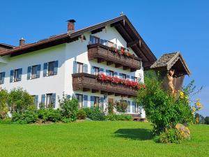 a large white building with balconies and flowers on it at Asbichlerhof in Bad Endorf