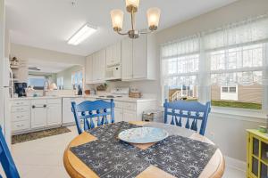 a kitchen with a table and two blue chairs and a dining room at Bethany Bay -- 37185 Harbor #3602 in Ocean View