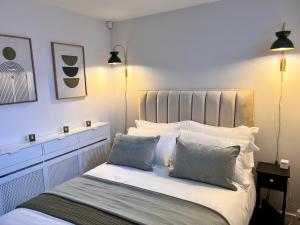 a bedroom with a white bed with two pillows at Holmfirth Hideaway in Holmfirth