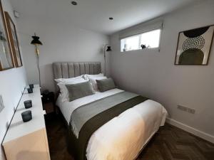 a bedroom with a bed and a window at Holmfirth Hideaway in Holmfirth