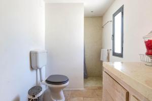 a white bathroom with a toilet and a sink at Lamia Madreperla by BarbarHouse in San Vito dei Normanni +30 photos