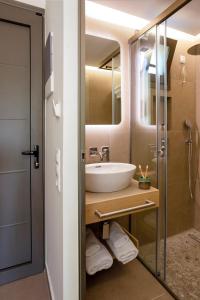 a bathroom with a sink and a mirror at Akti Retzika in Epanomi