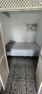 a white bed sitting on a floor in a room at La Siesta Apt in Salou +5 photos