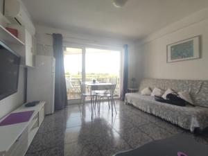 a living room with a couch and a table at La Siesta Apt in Salou