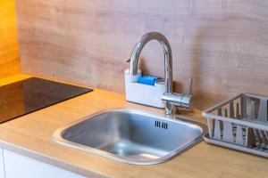 a stainless steel sink in a kitchen counter at Flexible SelfCheckIns 57 - Zagreb - Parking - New in Zagreb