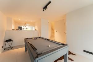 a pool table in the middle of a room at Modern & Spacious House in Kortrijk