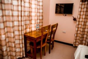 a dining room table and chairs in a room at Randa Family House - Moshi in Himo