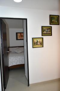 a bedroom with a door leading to a bedroom with a bed at ApartaHotel Modelia con Parqueadero in Bogotá