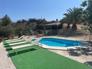 The swimming pool at or close to Casa Ramoncico. Finca el Campillo